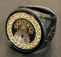 The deCAPitator BRUINS CENTENNIAL 1924 to 2024 ring bottle cap and can tab opener. Sizes 6 to 15 with ring sizer. Made of stainless steel.