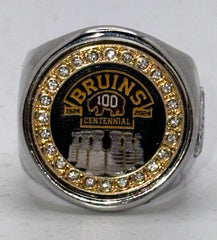 The deCAPitator BRUINS CENTENNIAL 1924 to 2024 ring bottle cap and can tab opener. Sizes 6 to 15 with ring sizer. Made of stainless steel.