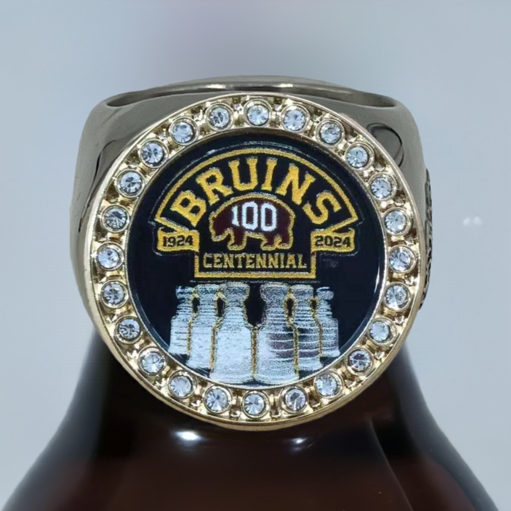 The deCAPitator BRUINS CENTENNIAL 1924 to 2024 ring bottle cap and can tab opener. Sizes 6 to 15 with ring sizer. Made of stainless steel.