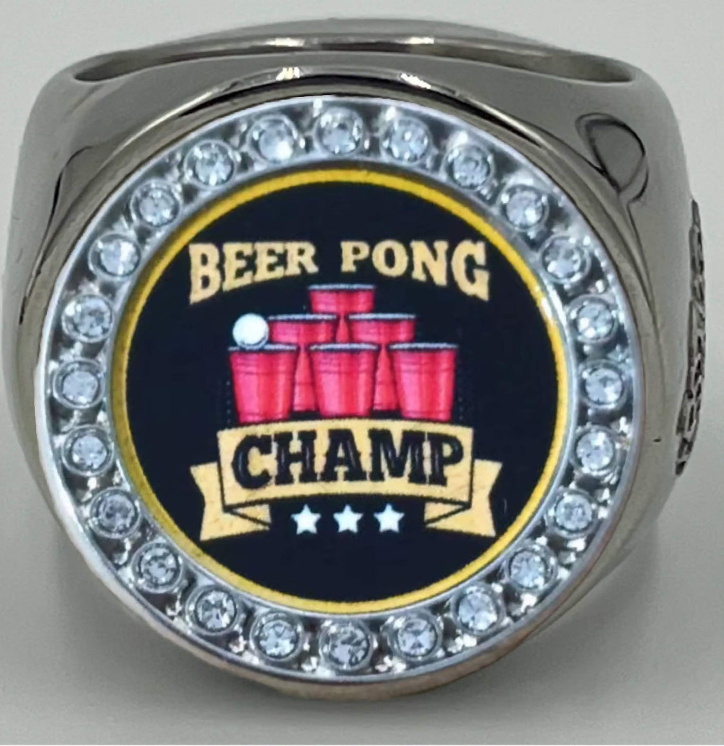 The deCAPitator BEER PONG CHAMP Ring bottle cap and can Ring goes on your middle finger for best leverage.